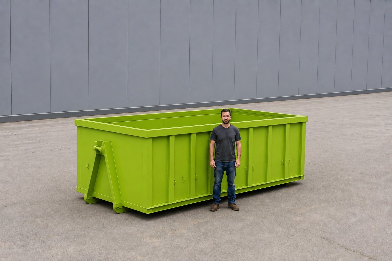 Lime green 20-yard roll-off container with a person standing alongside for scale, showing the ribbed steel sides and open top