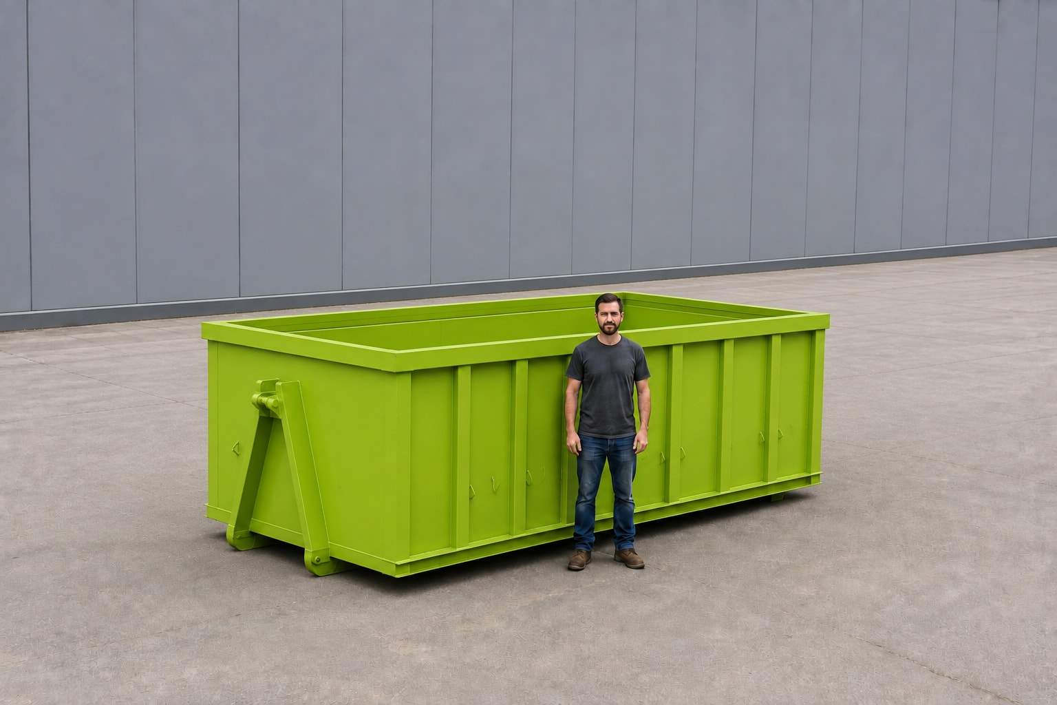 Lime green 20-yard roll-off container with a person standing alongside for scale, showing the ribbed steel sides and open top
