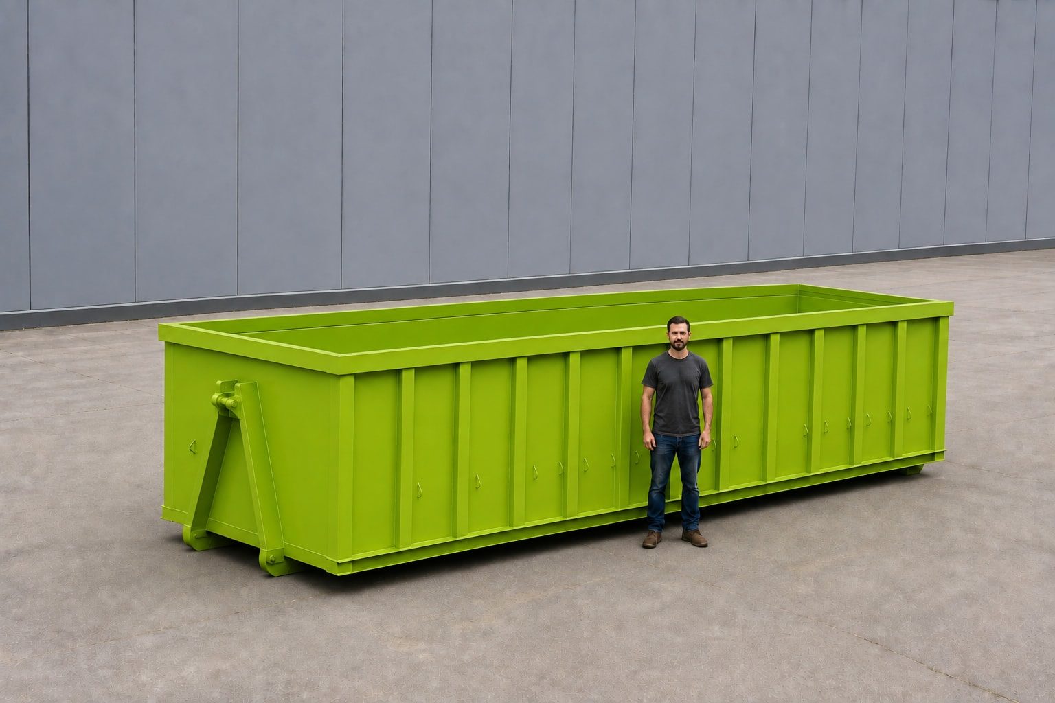 Lime green 30-yard roll-off container on a concrete pad, a person beside it reaching roughly to the top rail