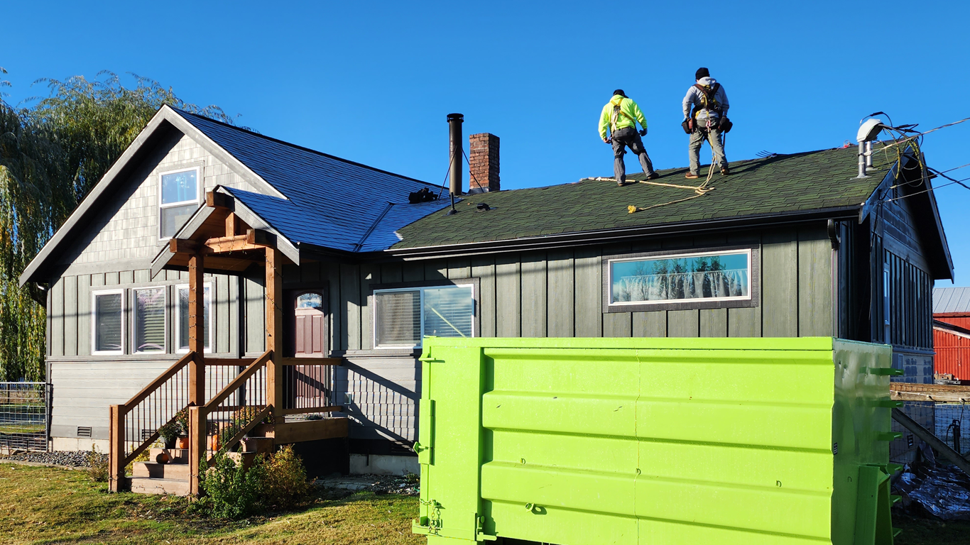 Workers Loading Dumpsters from Rainier Dumpster Rental.