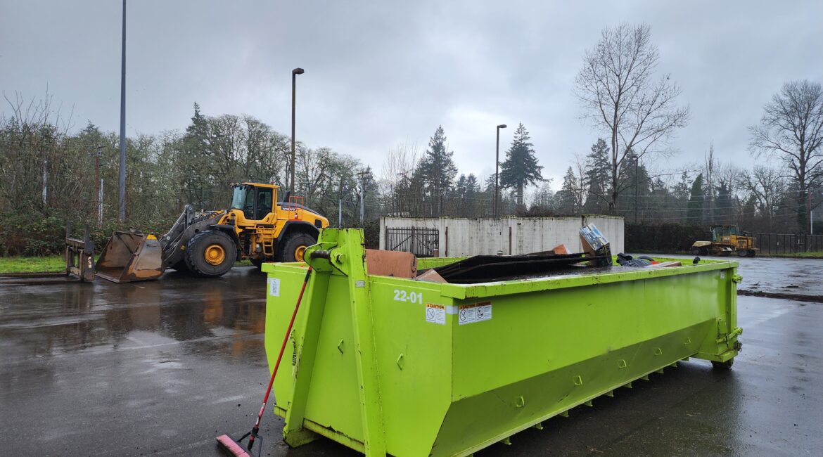 20-yard roll-off dumpster rental at Seattle construction jobsite with heavy equipment