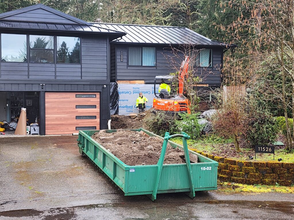 Rainier Dumpster Rental 10-yard rock box filled with dirt at a residential excavation site in Bellevue, WA.
