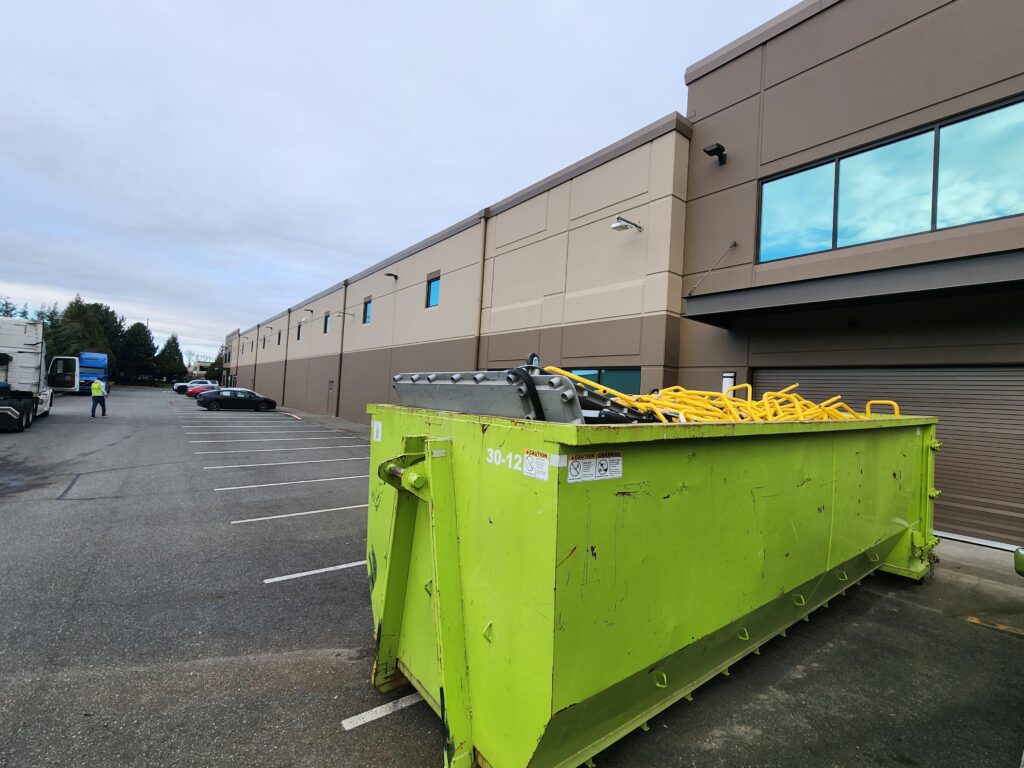 Rainier Dumpster Rental 30-yard commercial roll-off bin delivered to an industrial job site in Renton, WA.